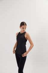 An easy and flattering fit that floats away from your body. With open back so you can show off your bra details. Also, it has beautiful drapes details at the back. Quick dry, light and comfortable on your skin. From all day, practicing to pacing you decide. It is a staple piece!